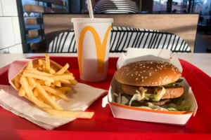 The images shows mcdonalds 4 For $4 Deal. In this image there is burger, fries and drink