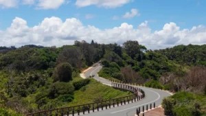 The image is of a road and is for those who want to plan a perfect road trip. There is sky visible and road is seems like undending.