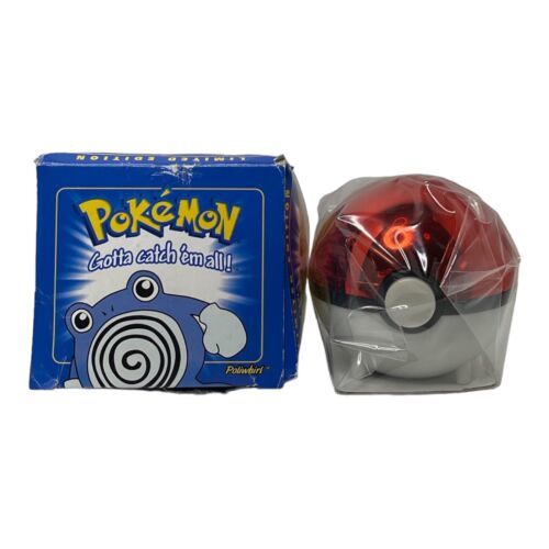 A vintage Burger king Pokémon toy set featuring a Poké Ball and a Poliwhirl figure. The Poké Ball is red and white, with a transparent cover revealing the Poliwhirl inside. The packaging is a blue and white box with the Pokémon logo and the phrase "Gotta catch 'em all!"